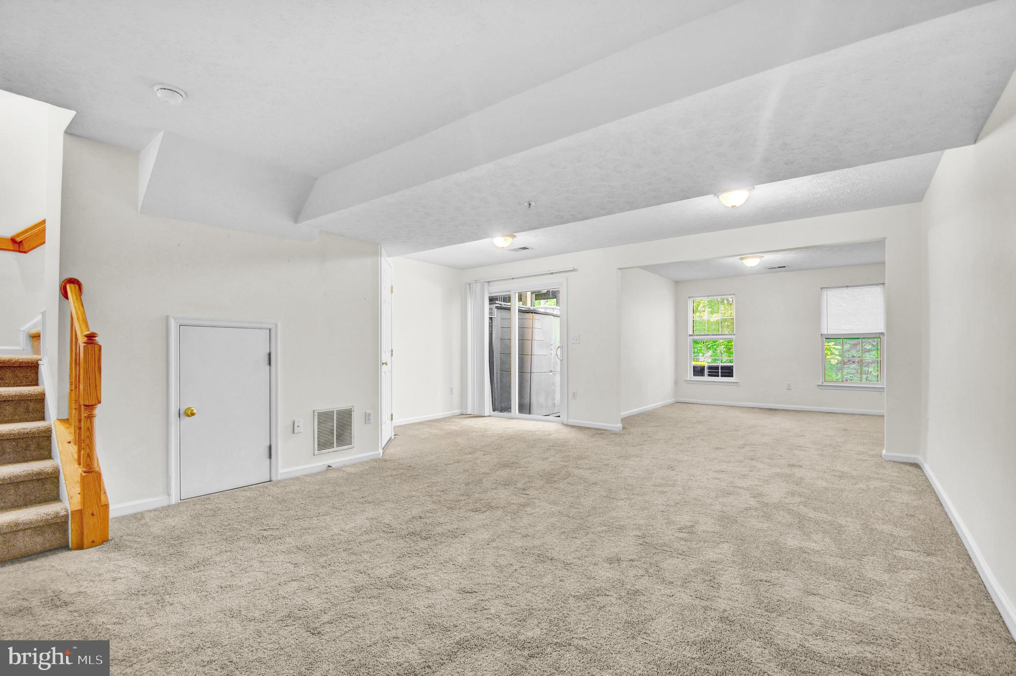 8036 Silver Fox Way Chesapeake Beach, MD 20732 - Photo 18 of 22 a view of an empty room with window and wooden floor