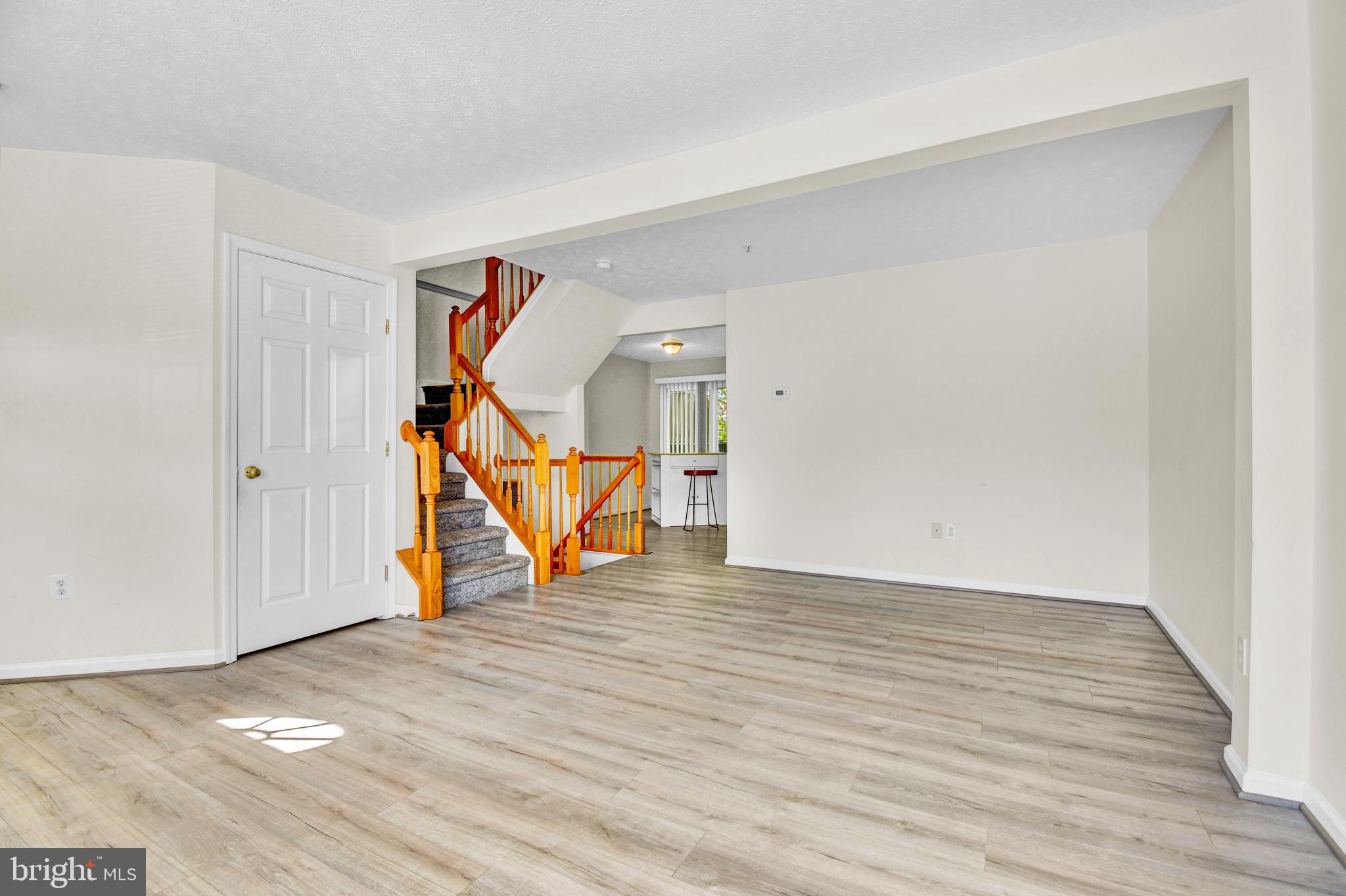 8036 Silver Fox Way Chesapeake Beach, MD 20732 - Photo 5 of 22 a view of an empty room with wooden floor
