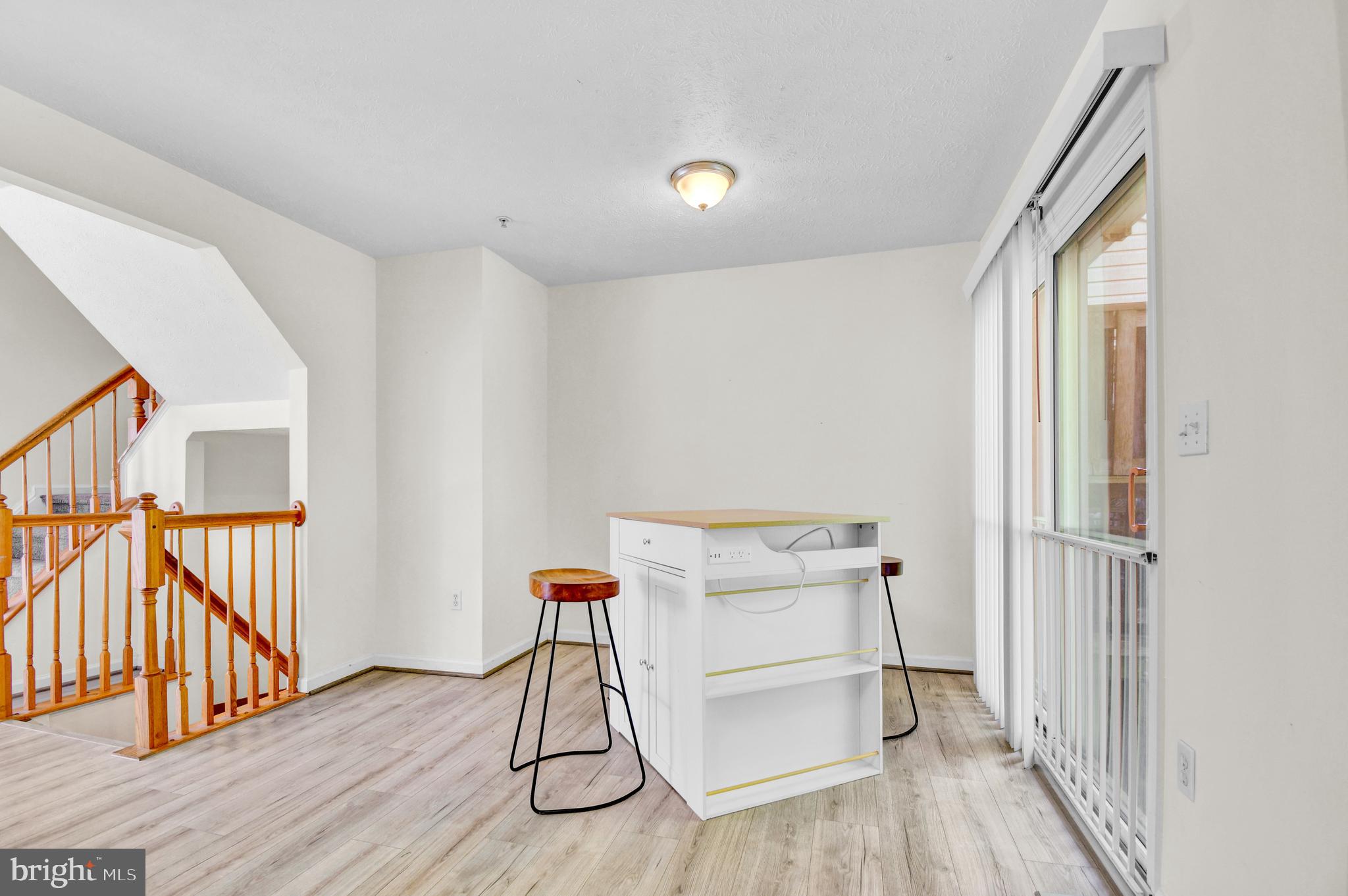 8036 Silver Fox Way Chesapeake Beach, MD 20732 - Photo 6 of 22 a view of a room with wooden floor and stairs