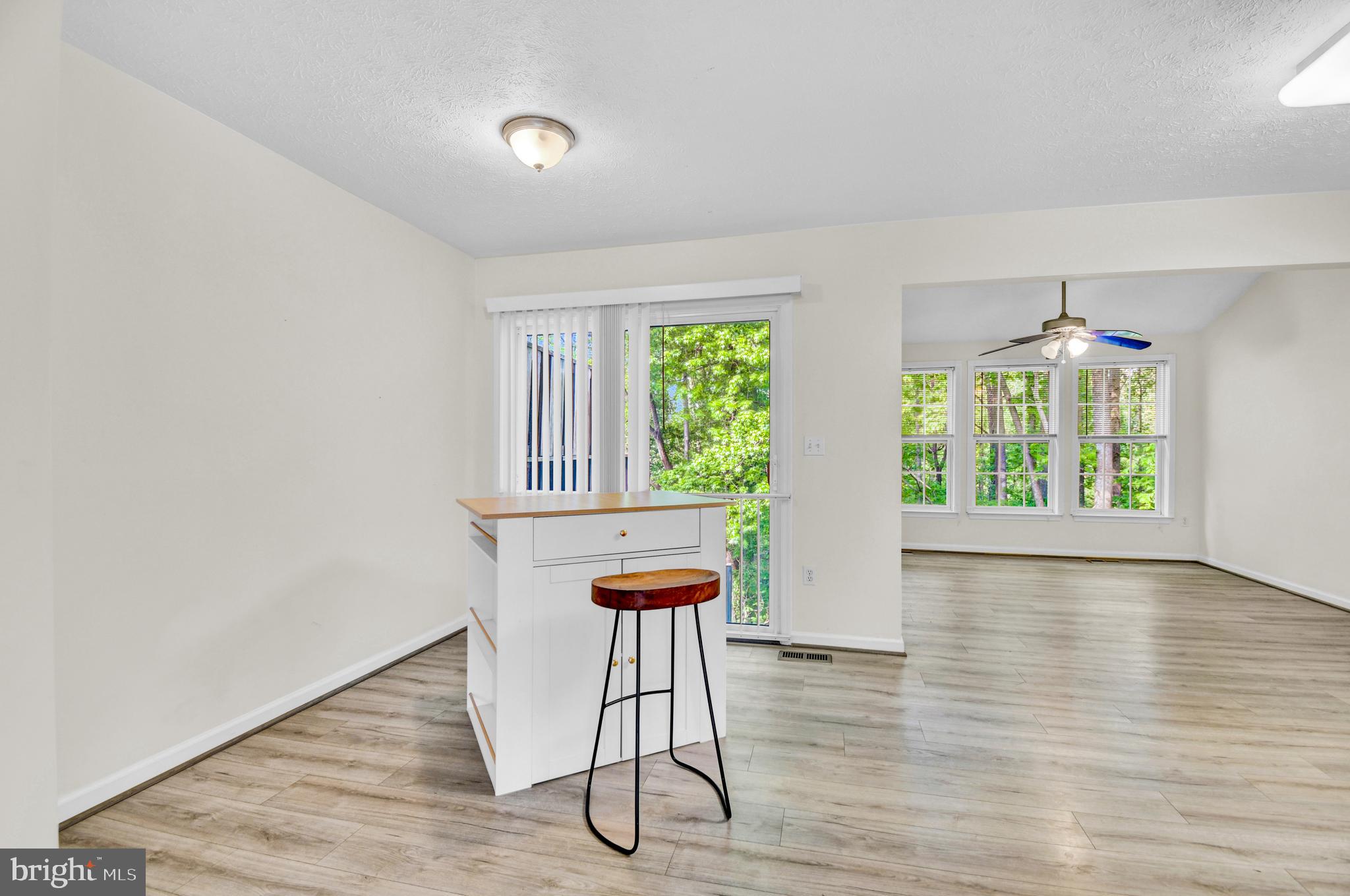 8036 Silver Fox Way Chesapeake Beach, MD 20732 - Photo 7 of 22 an empty room with wooden floor and windows