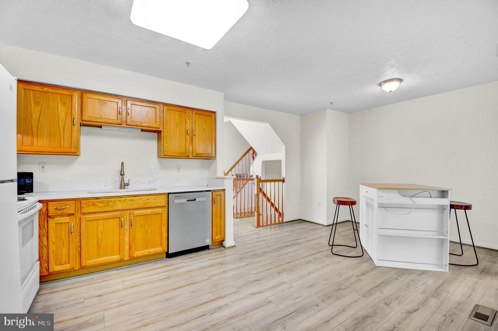 8036 Silver Fox Way Chesapeake Beach, MD 20732 - Photo 9 of 22 a very nice looking room with wooden floor and cabinets