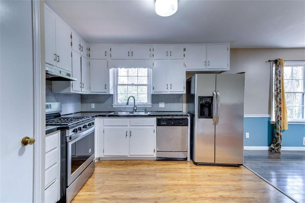 3959 Emerald Springs Court Decatur, GA 30035 - Photo 5 of 27 a kitchen with stainless steel appliances granite countertop a stove a refrigerator and a sink