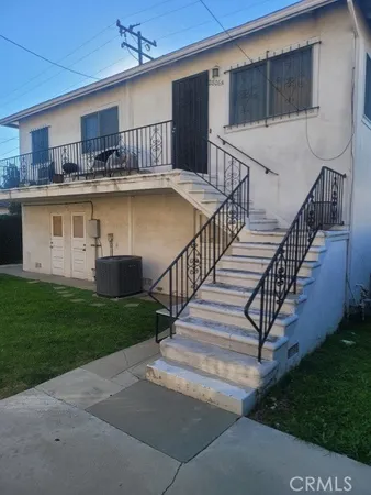 a view of a house with backyard and deck