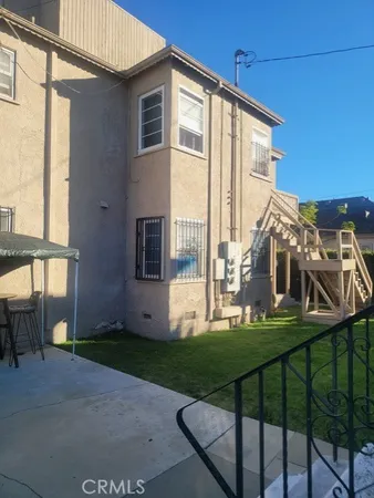 a front view of a house with a yard table and chairs