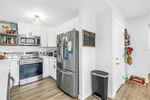 a kitchen with stainless steel appliances a stove a refrigerator and a refrigerator