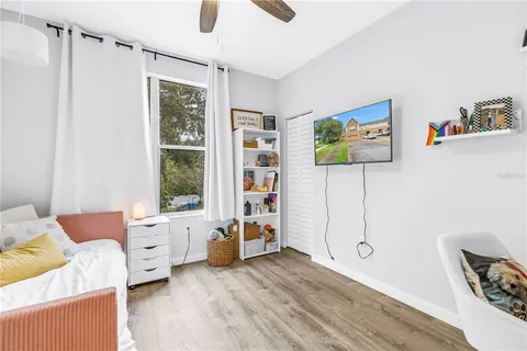 a bedroom with furniture and a window