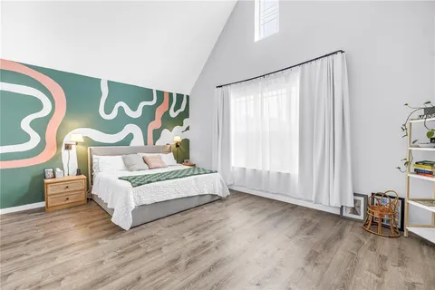 a view of a room with wooden floor and furniture