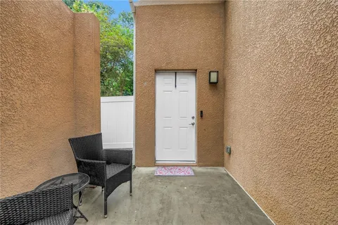 a backyard of a house with table and chairs