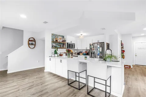 a kitchen with stainless steel appliances kitchen island granite countertop a refrigerator and a stove