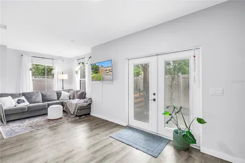 a living room with furniture potted plant and a window
