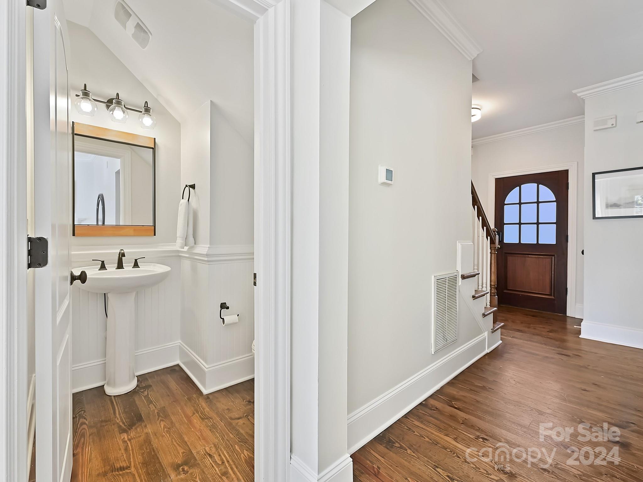 820 Millbrook Road Charlotte, NC 28211 - Photo 17 of 31 a view of a hallway with wooden floor and a living room