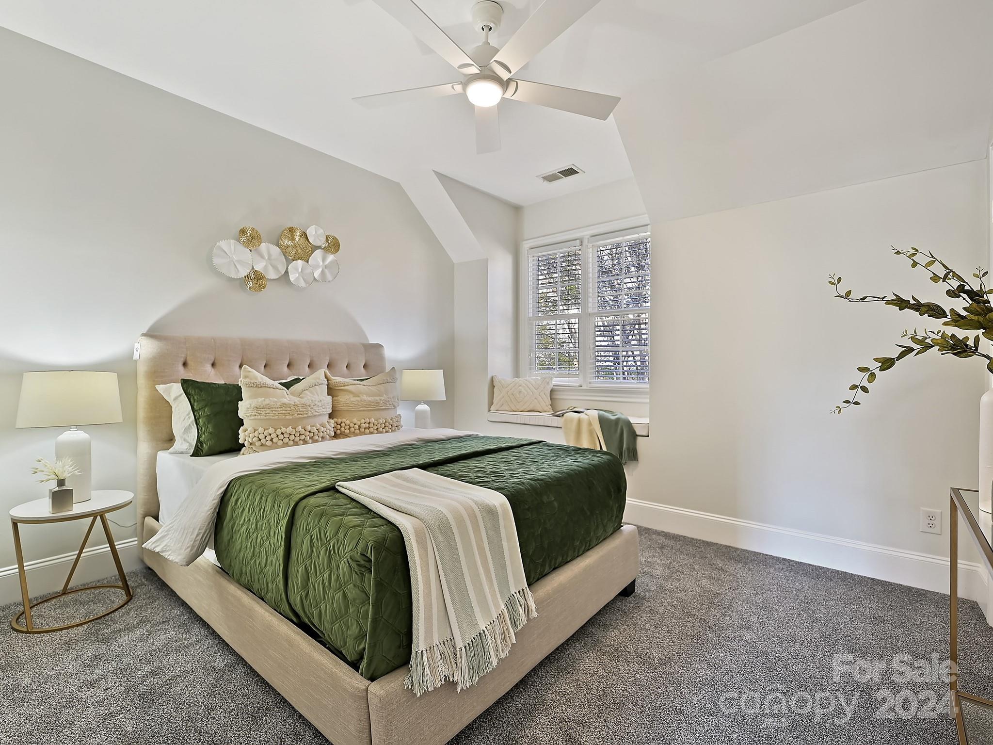 820 Millbrook Road Charlotte, NC 28211 - Photo 24 of 31 a bedroom with a bed and a chandelier