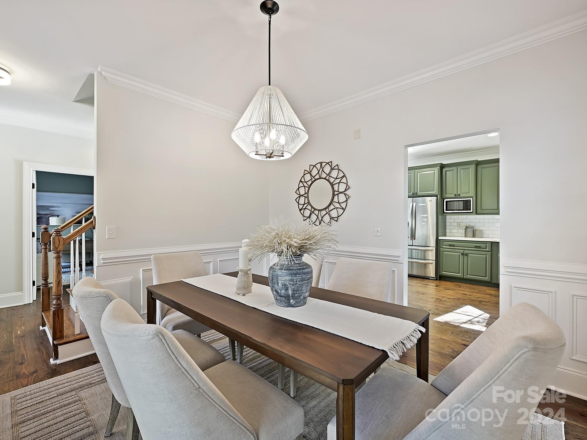 820 Millbrook Road Charlotte, NC 28211 - Photo 5 of 31 a view of a dining room with furniture a chandelier and wooden floor