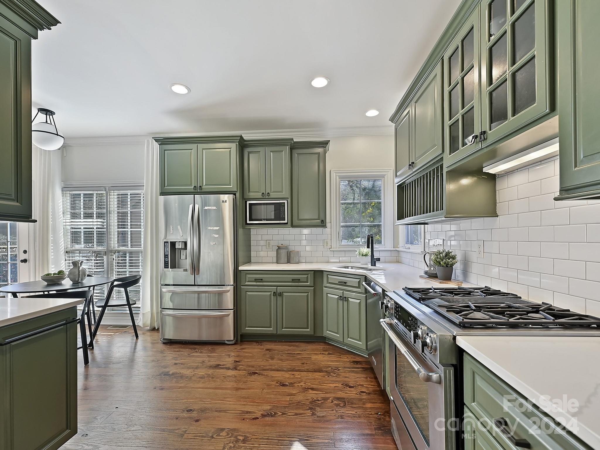 820 Millbrook Road Charlotte, NC 28211 - Photo 8 of 31 a kitchen with stainless steel appliances granite countertop a stove and a refrigerator
