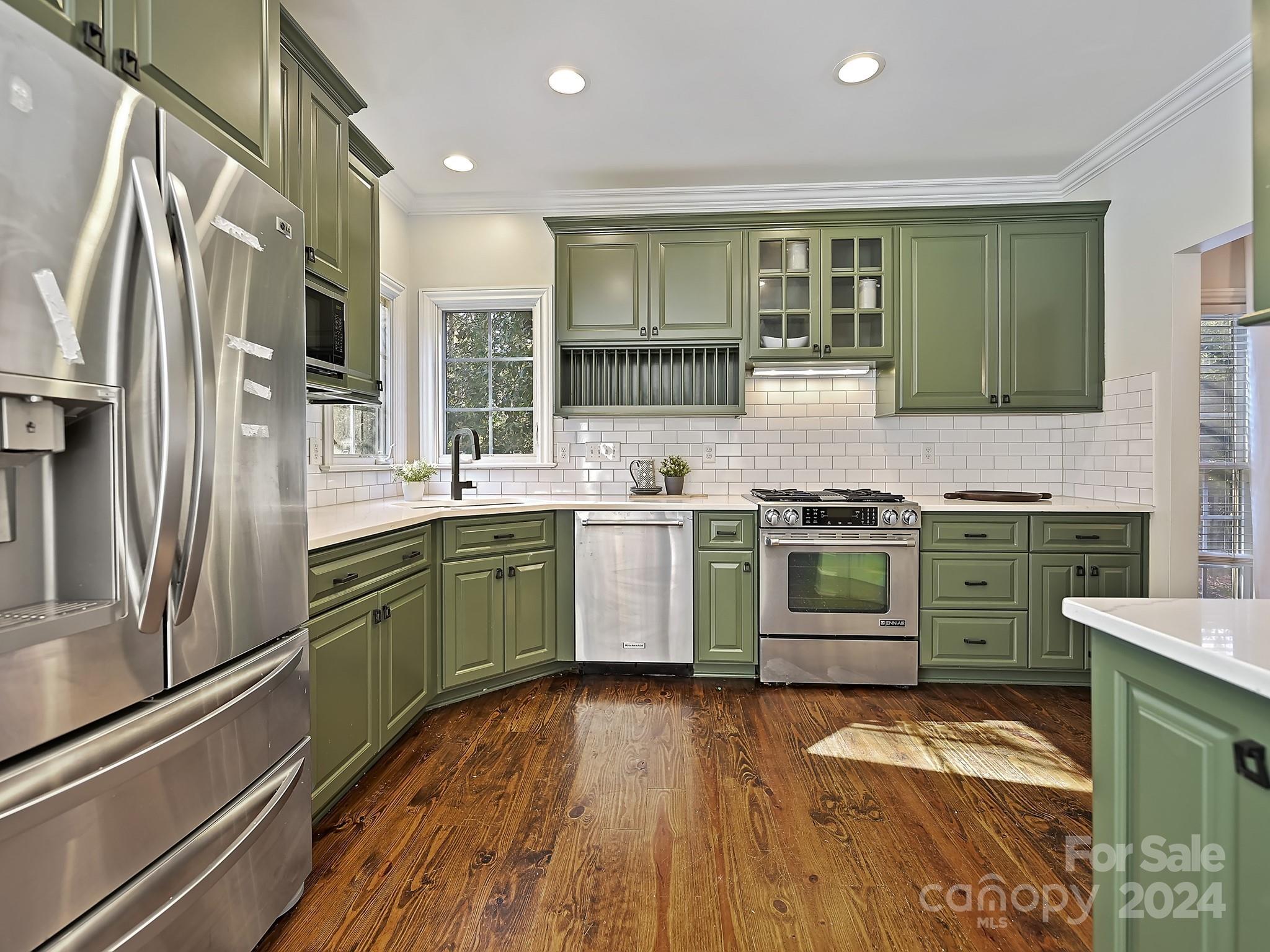 820 Millbrook Road Charlotte, NC 28211 - Photo 10 of 31 a kitchen with stainless steel appliances a sink cabinets and wooden floor