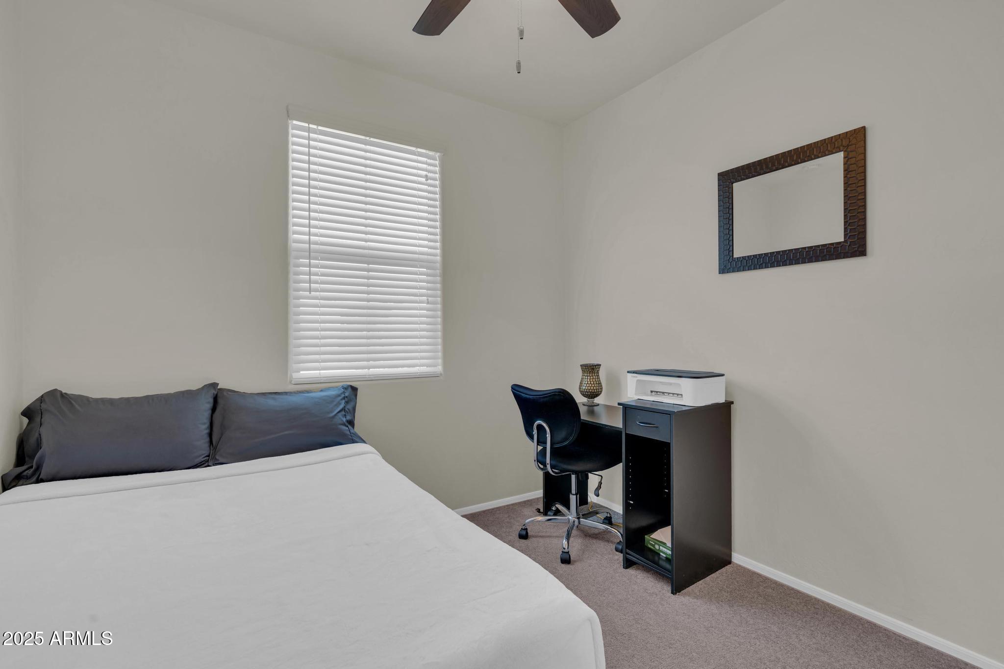 6556 East Via Arroyo Azul Tucson, AZ 85756 - Photo 11 of 75 a bedroom with a bed and a desk