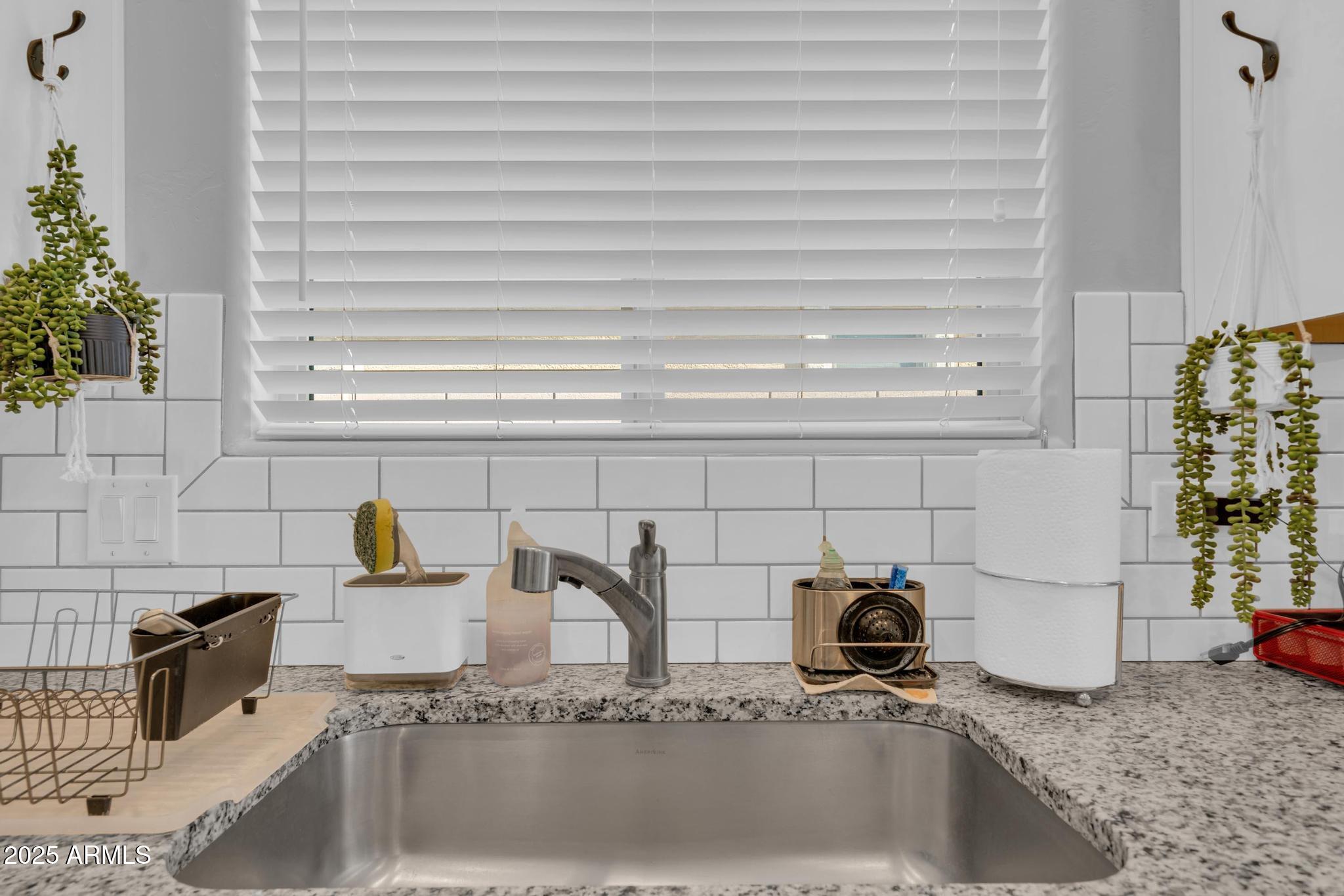 6556 East Via Arroyo Azul Tucson, AZ 85756 - Photo 18 of 75 a bathroom with a granite countertop sink and a granite top