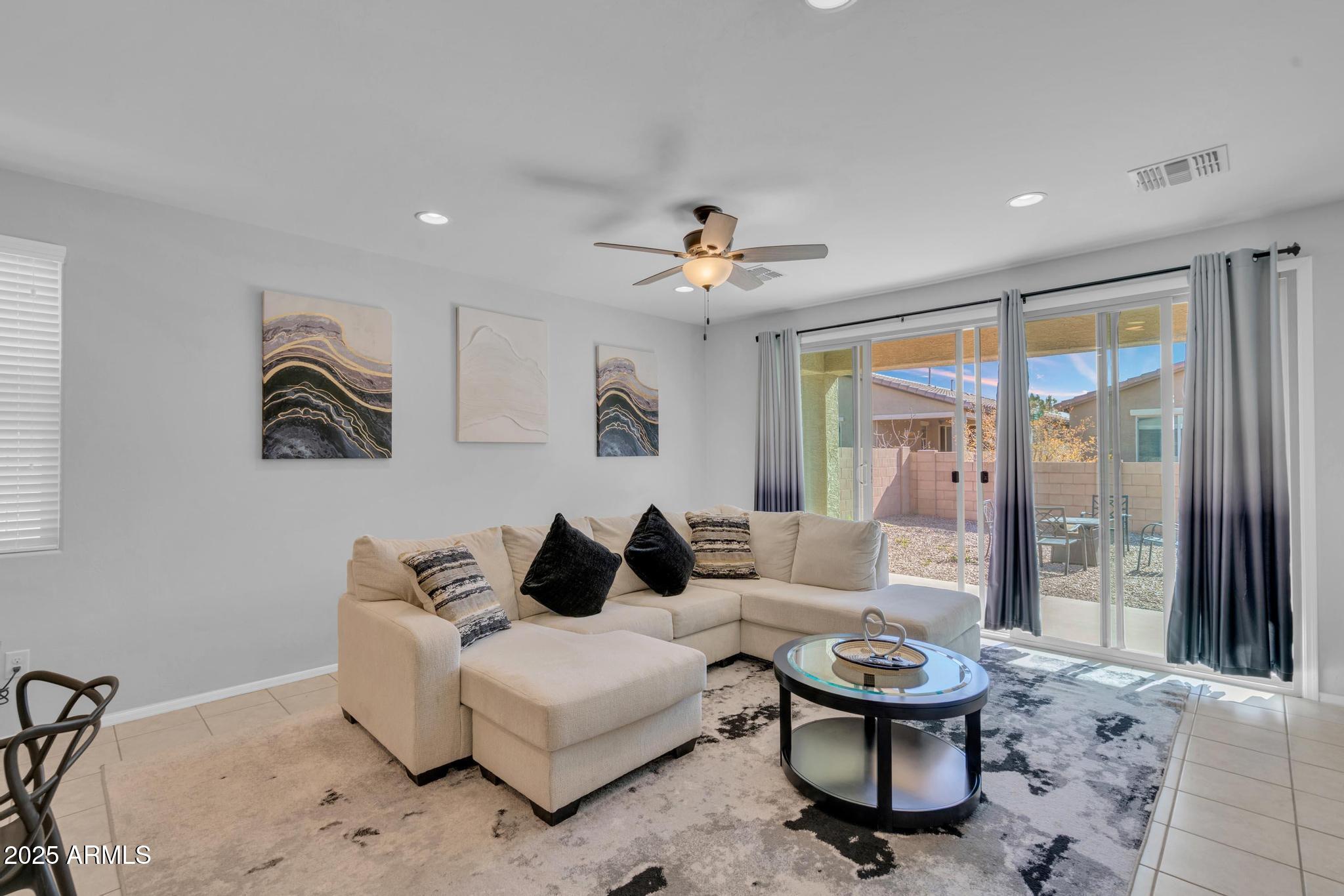 6556 East Via Arroyo Azul Tucson, AZ 85756 - Photo 24 of 75 a living room with furniture and a chandelier