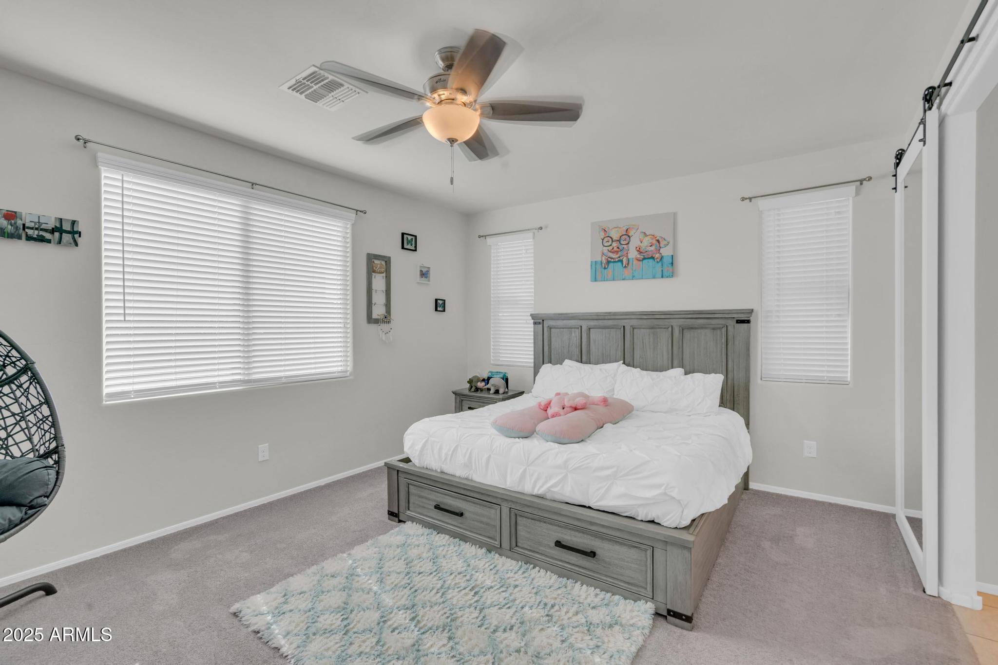 6556 East Via Arroyo Azul Tucson, AZ 85756 - Photo 29 of 75 a bedroom with a bed and a chandelier