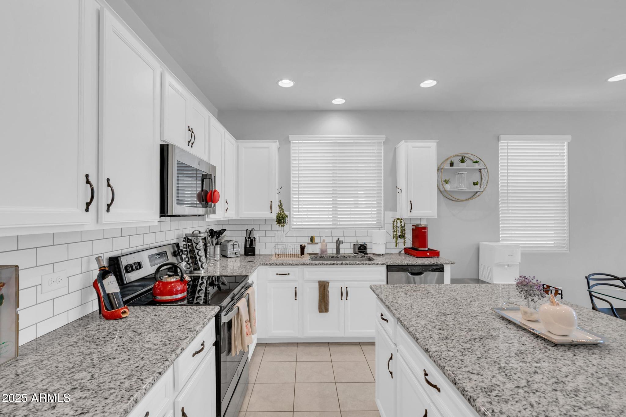 6556 East Via Arroyo Azul Tucson, AZ 85756 - Photo 2 of 75 a kitchen with stainless steel appliances granite countertop a sink stove and cabinets