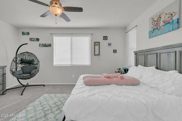 a living room with furniture a flat screen tv and kitchen view