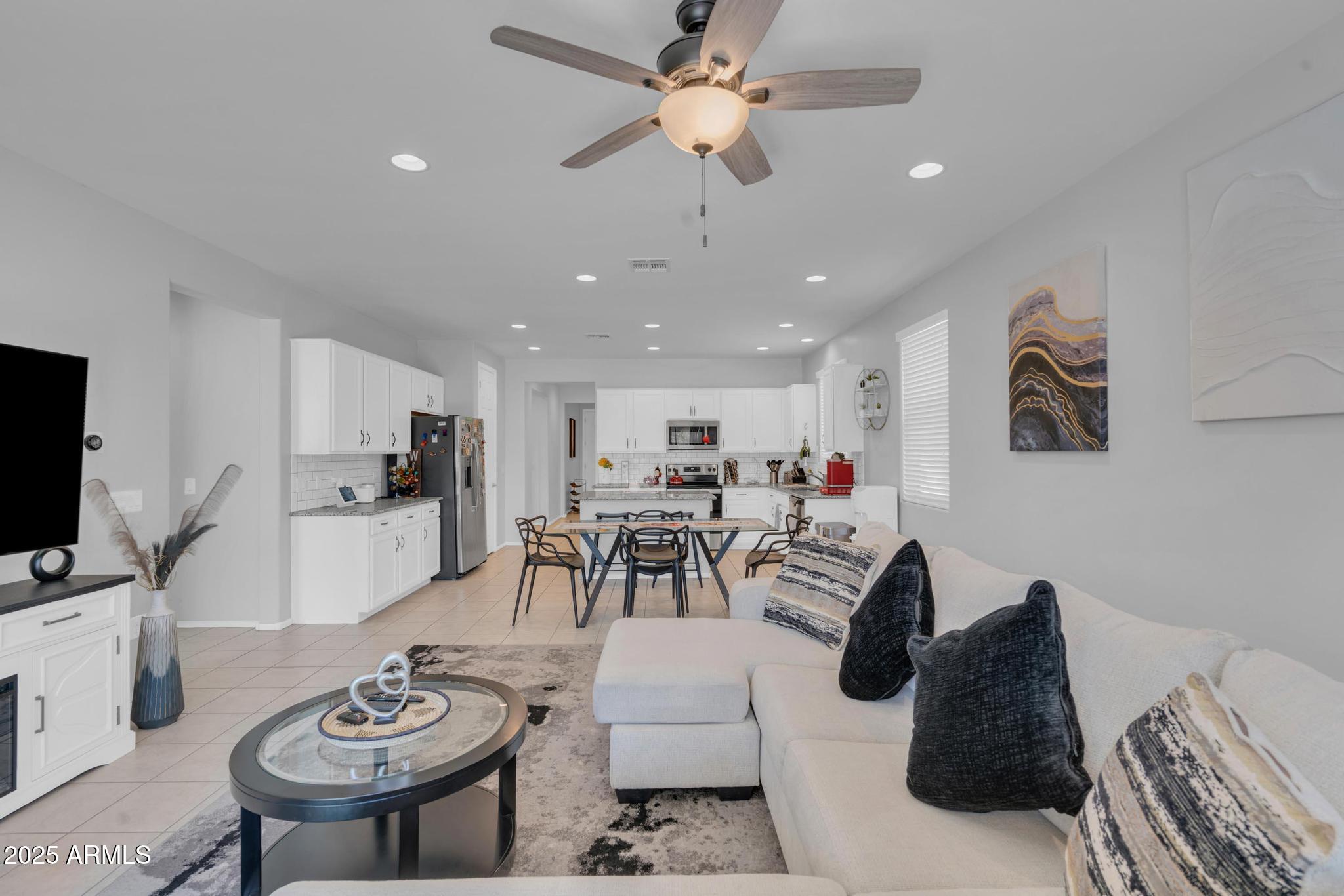 6556 East Via Arroyo Azul Tucson, AZ 85756 - Photo 41 of 75 a living room with furniture a flat screen tv and kitchen view