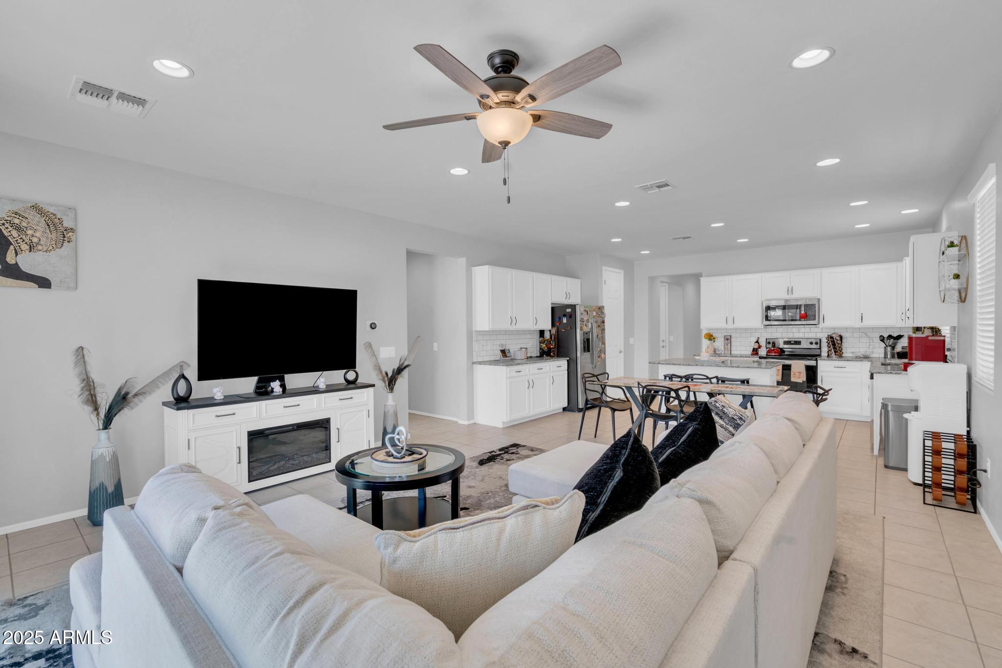 6556 East Via Arroyo Azul Tucson, AZ 85756 - Photo 42 of 75 a living room with furniture and a flat screen tv