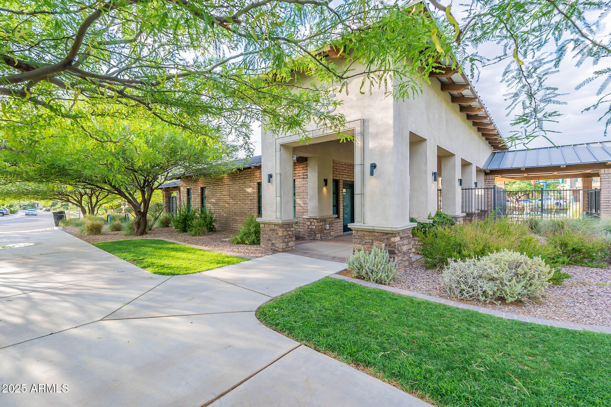 6556 East Via Arroyo Azul Tucson, AZ 85756 - Photo 57 of 75 a front view of a house with a yard and trees