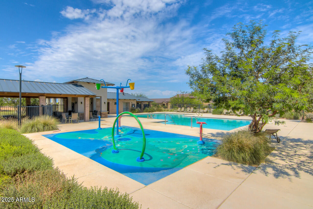 6556 East Via Arroyo Azul Tucson, AZ 85756 - Photo 71 of 75 a view of a swimming pool with a garden and two chairs