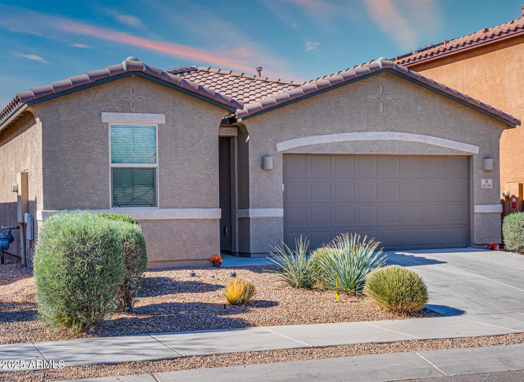 6556 East Via Arroyo Azul Tucson, AZ 85756 - Photo 74 of 75 a house that has a lot of plants in it