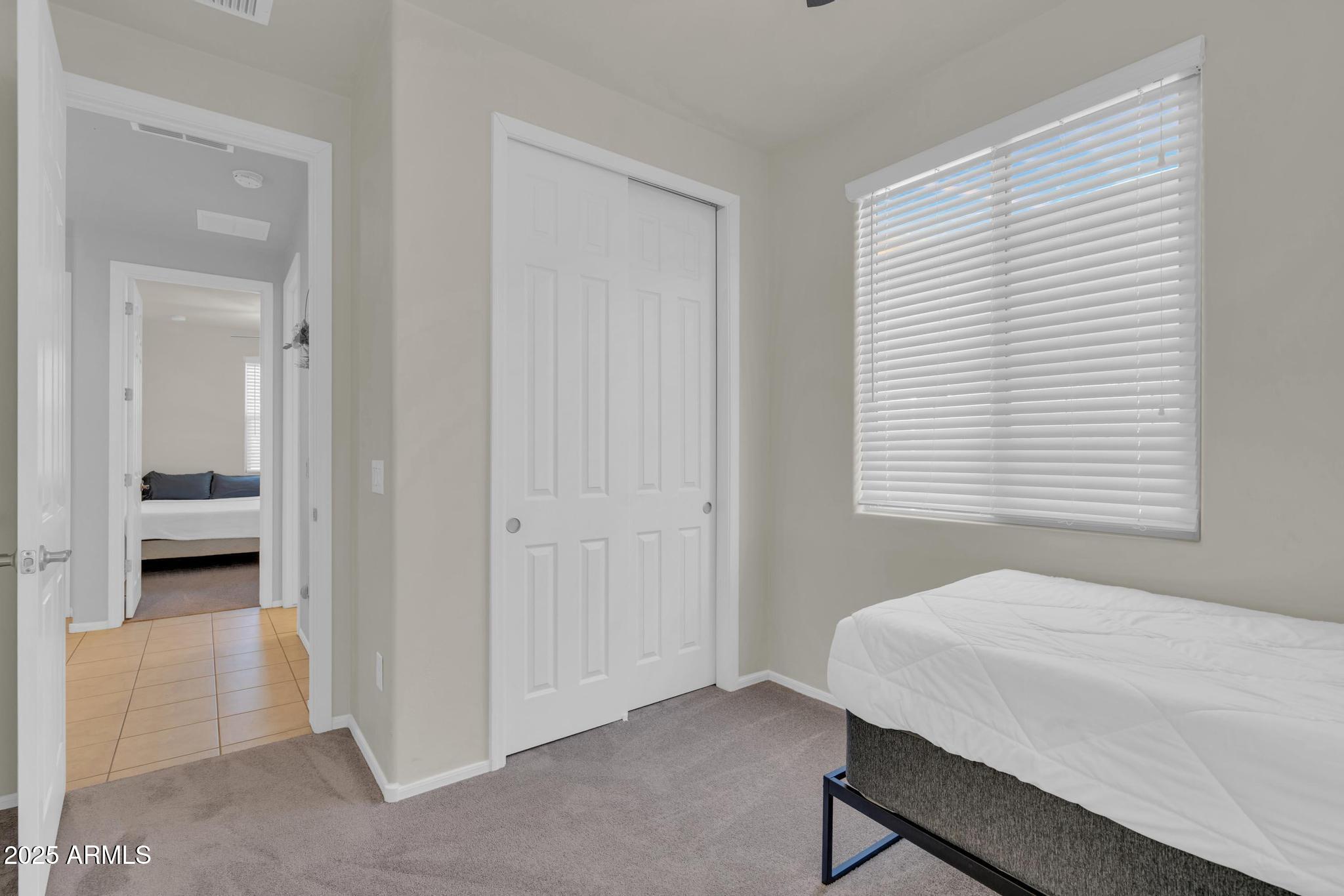 6556 East Via Arroyo Azul Tucson, AZ 85756 - Photo 7 of 75 a bedroom with a bed and a window