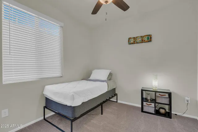 a bedroom with a bed and a desk