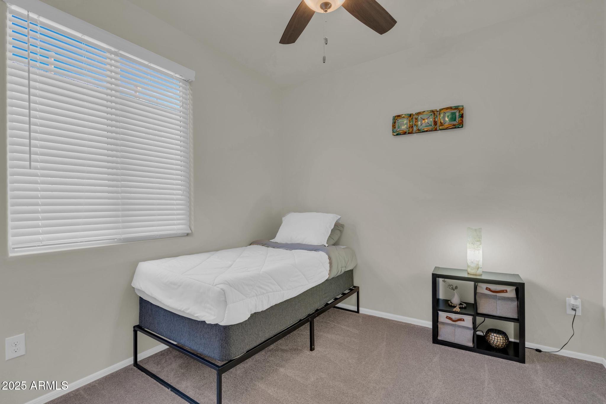 6556 East Via Arroyo Azul Tucson, AZ 85756 - Photo 8 of 75 a bedroom with a bed and a window