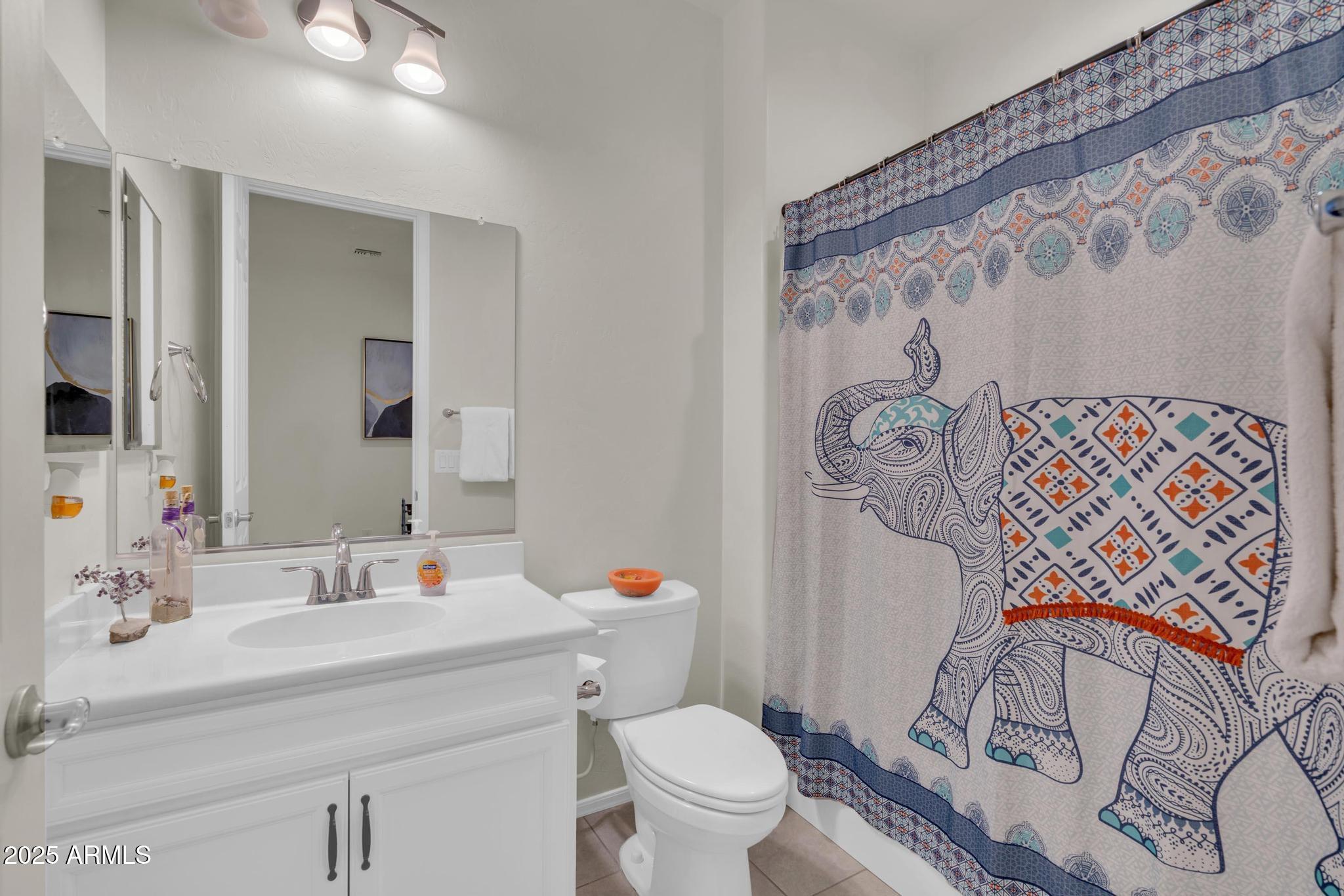 6556 East Via Arroyo Azul Tucson, AZ 85756 - Photo 9 of 75 a bathroom with a toilet sink and mirror