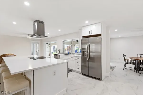 a kitchen with refrigerator cabinets and dining table