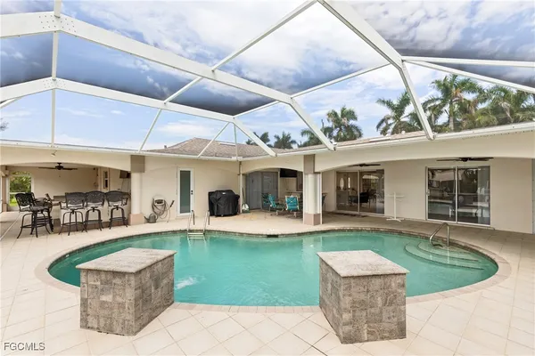 a view of a house with swimming pool and sitting area