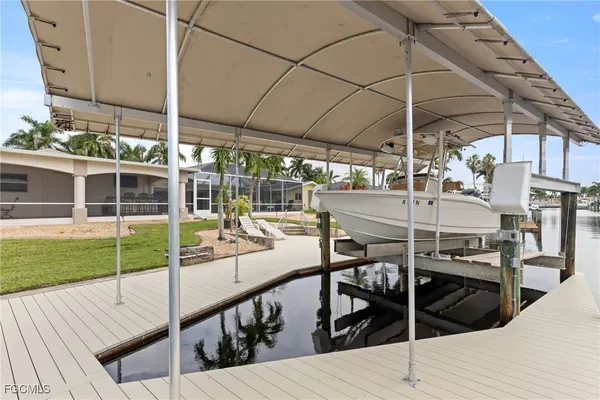 a view of a roof deck with table and chairs under an umbrella