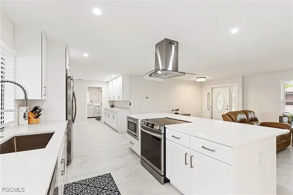 a kitchen with a stove a sink and a refrigerator