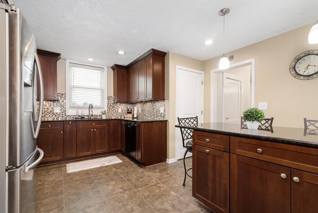 112 Country Club Road Butler, PA 16002 - Photo 8 of 22 a kitchen with granite countertop a refrigerator and a sink