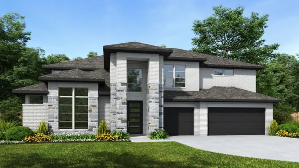 a front view of a house with a garden and yard