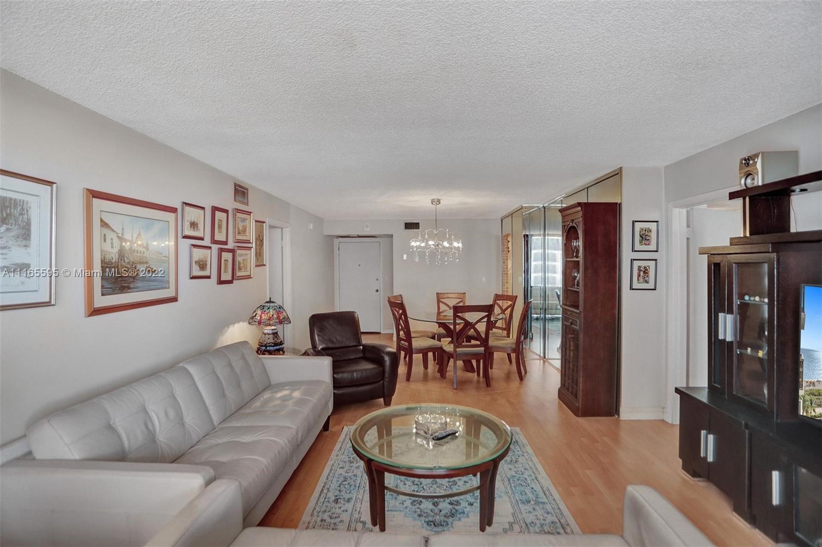 Millionaire's Row Miami Beach, FL 33140 - Photo 11 of 41 a living room with furniture a large window and bookshelf