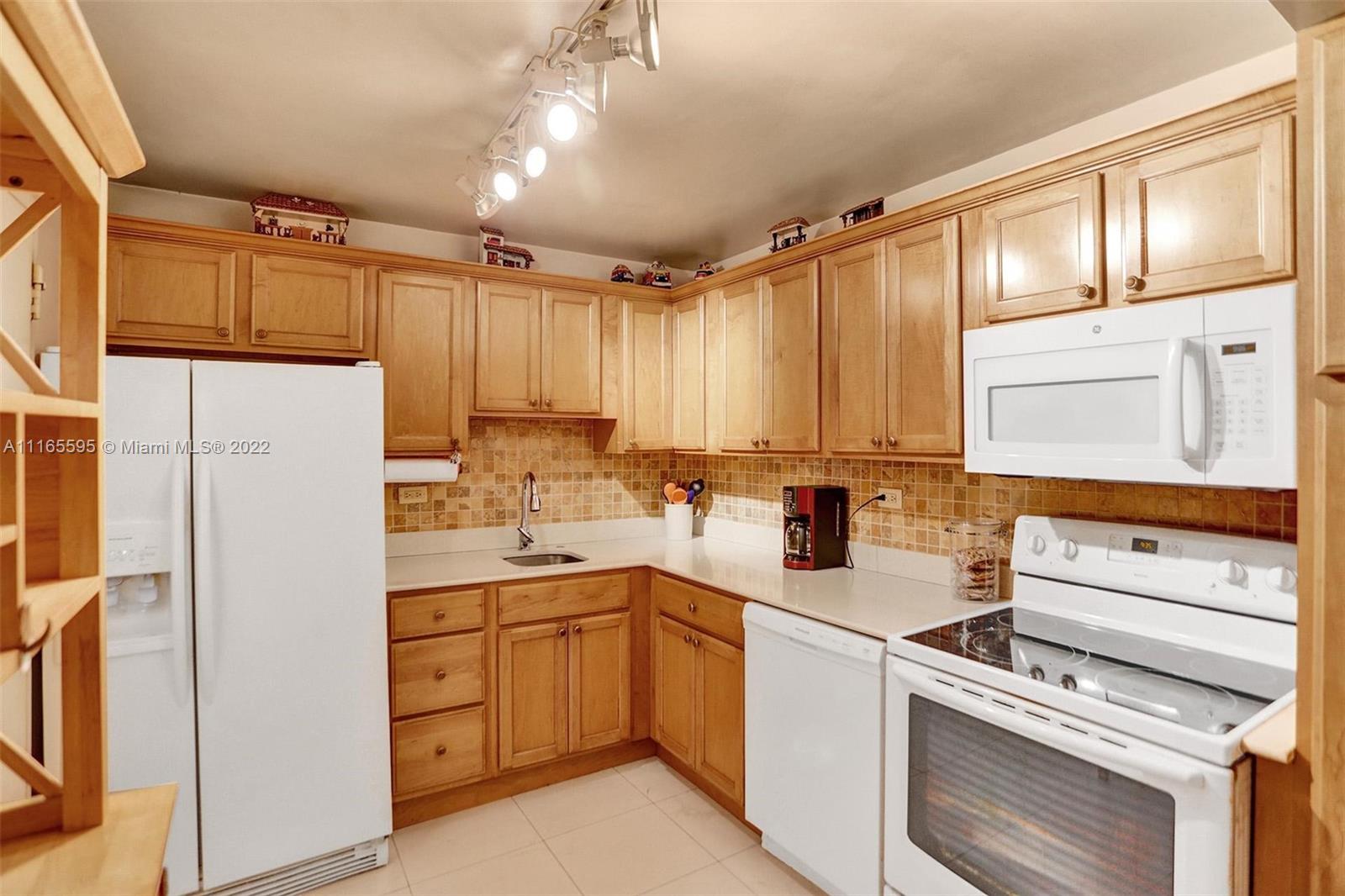 Millionaire's Row Miami Beach, FL 33140 - Photo 14 of 41 a kitchen with a sink stove and refrigerator