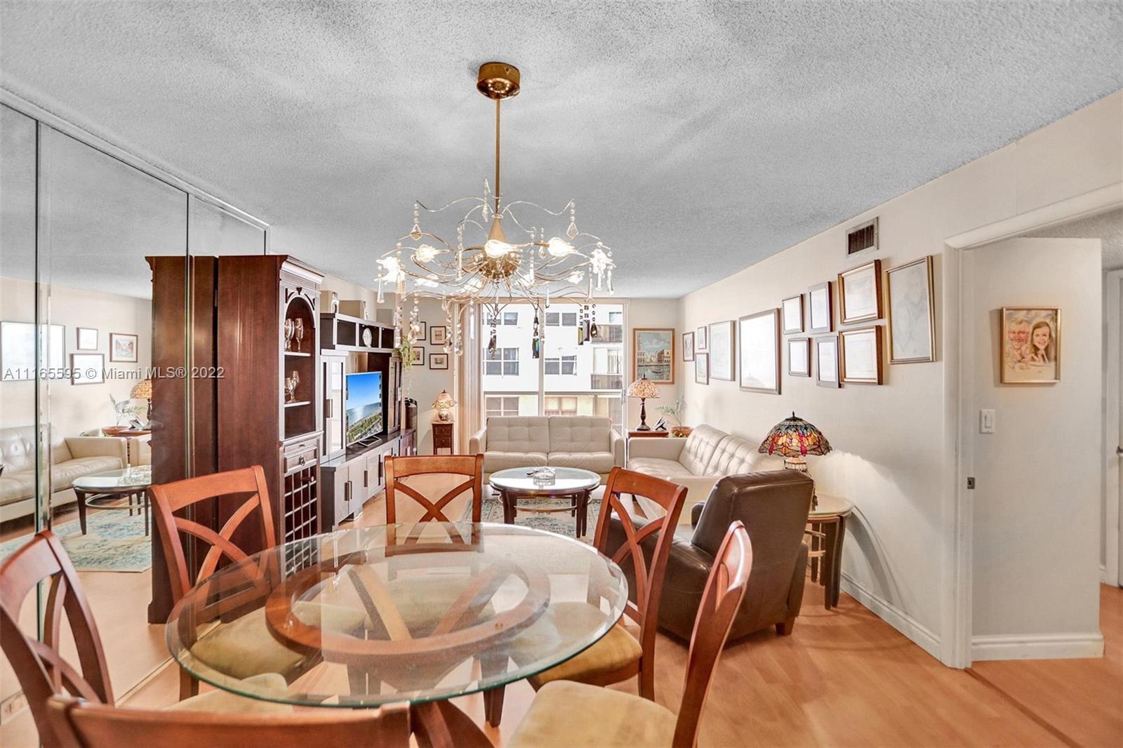 Millionaire's Row Miami Beach, FL 33140 - Photo 17 of 41 a view of a dining room with furniture a chandelier and wooden floor