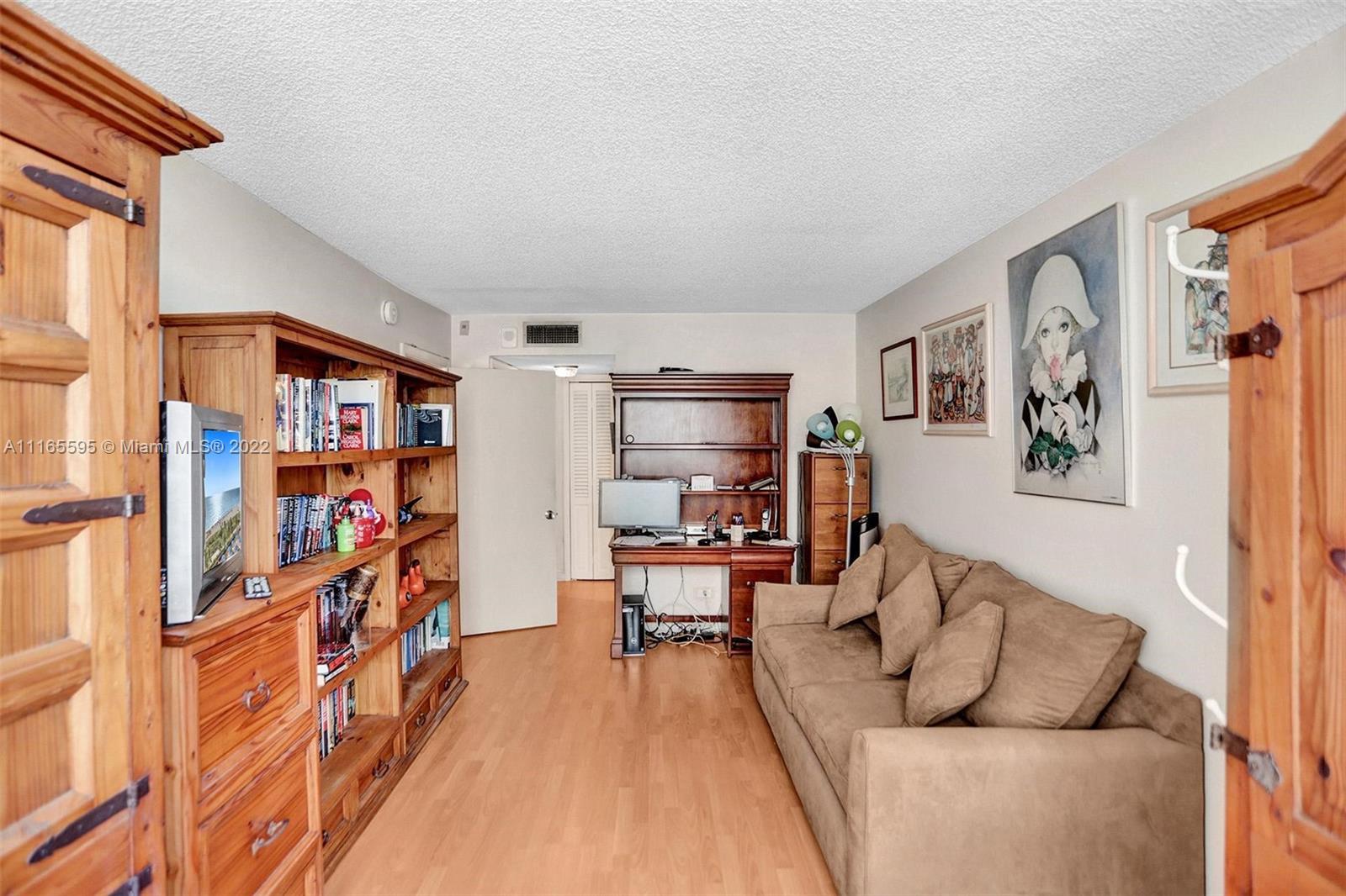 Millionaire's Row Miami Beach, FL 33140 - Photo 19 of 41 a living room with furniture and a book shelf