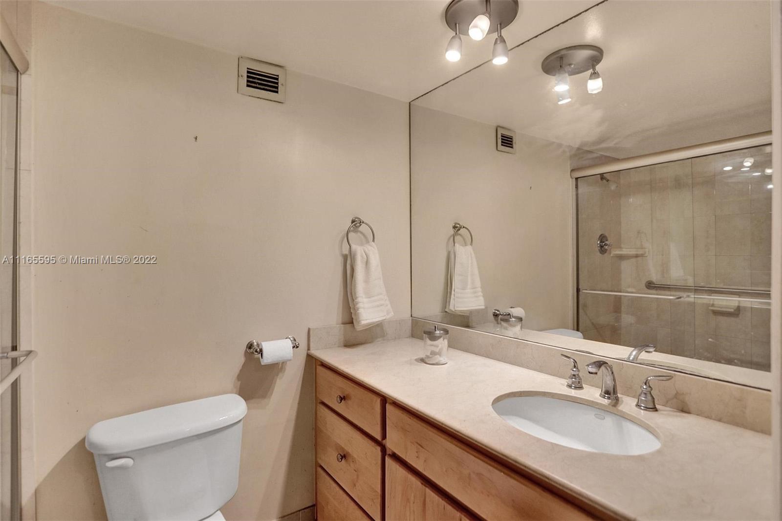 Millionaire's Row Miami Beach, FL 33140 - Photo 22 of 41 a bathroom with a toilet a sink a mirror and vanity