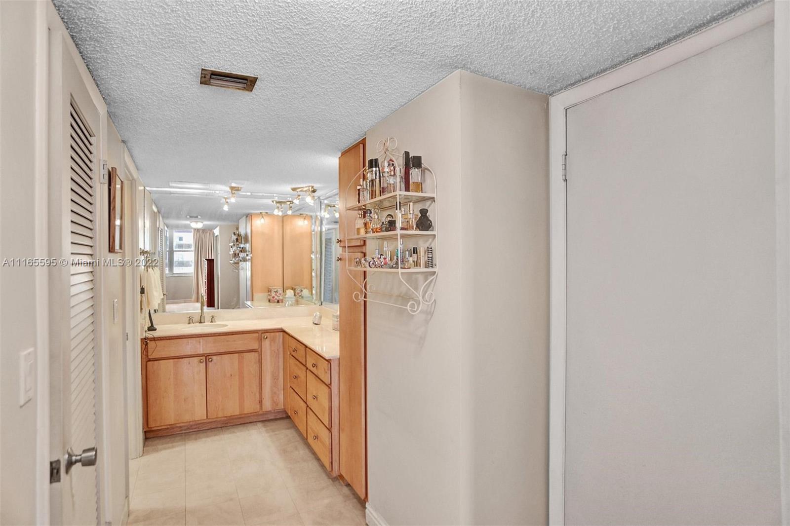 Millionaire's Row Miami Beach, FL 33140 - Photo 35 of 41 a kitchen with white cabinets and refrigerator