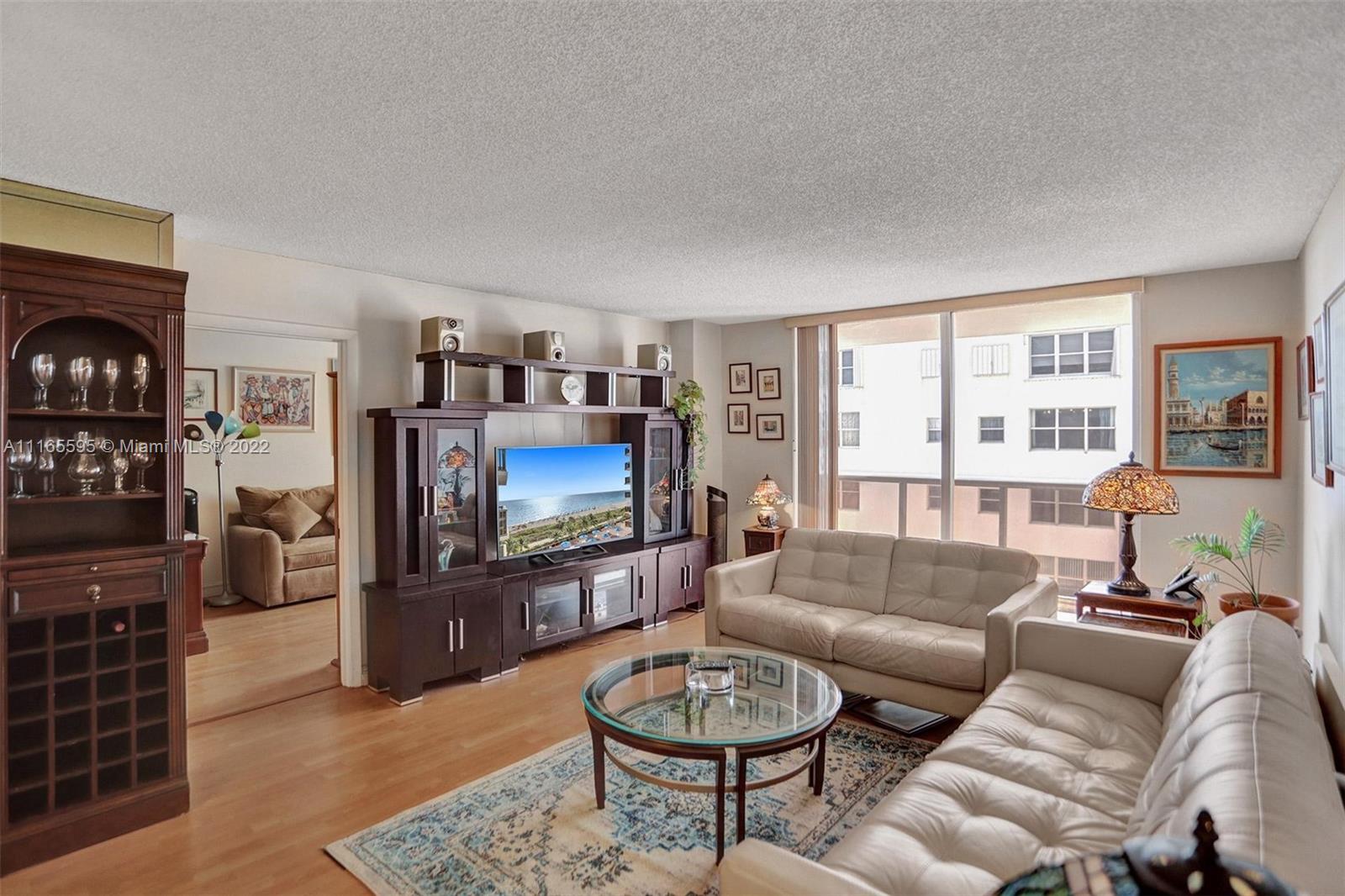 Millionaire's Row Miami Beach, FL 33140 - Photo 6 of 41 a living room with furniture a flat screen tv and a fireplace