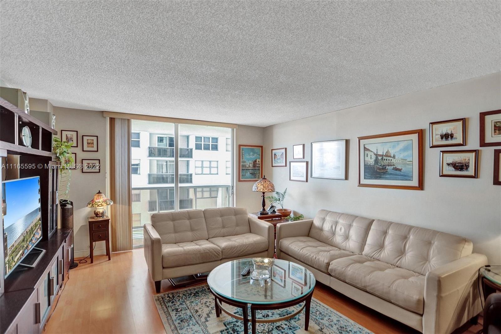 Millionaire's Row Miami Beach, FL 33140 - Photo 7 of 41 a living room with furniture a flat screen tv and a window