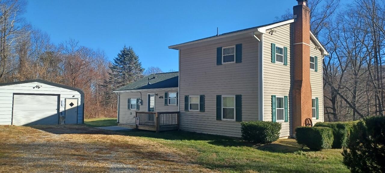 7673 Bent Mountain Road Roanoke, VA 24018 - Photo 4 of 10 a front view of a house with garden
