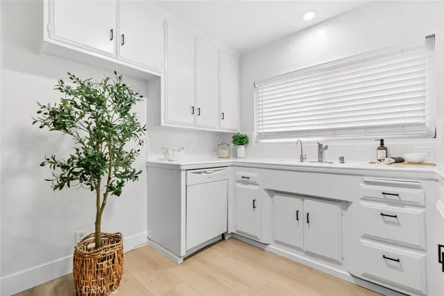 a kitchen with sink and cabinets
